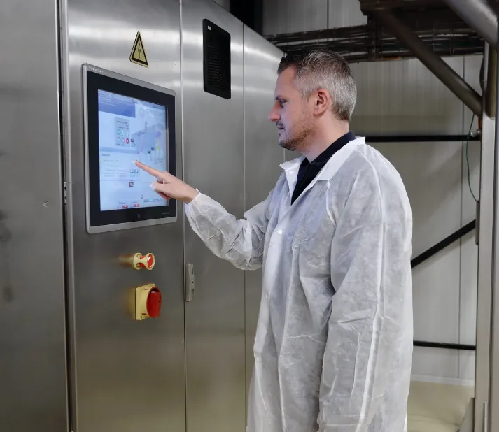 Engineer controlling the automated kneading system through a HMI panel